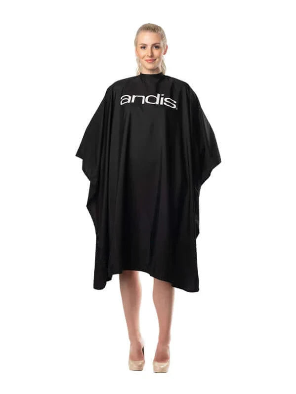 Person wearing a black Andis hairdressing cape on a white background