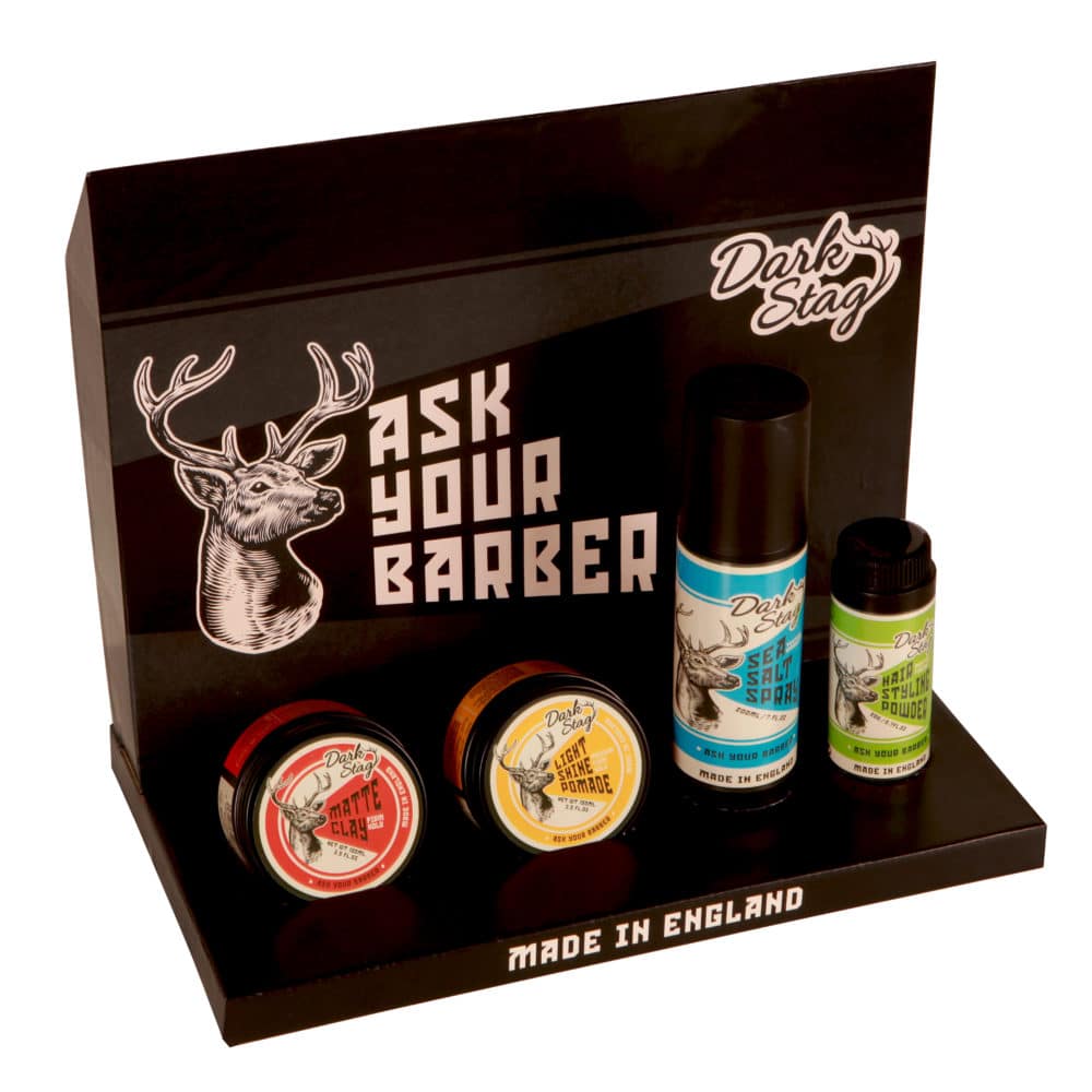 Set of grooming products with 'Dark Stag' branding on a black display stand.