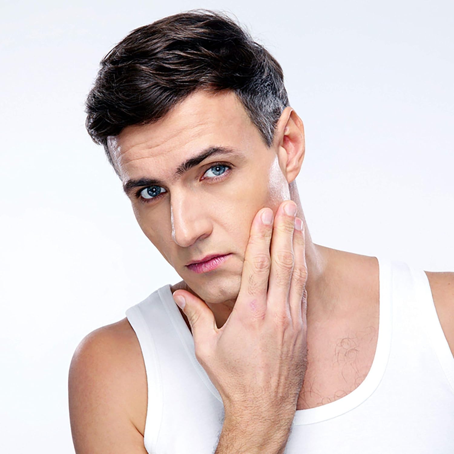 Man applying cream to his face with a white background
