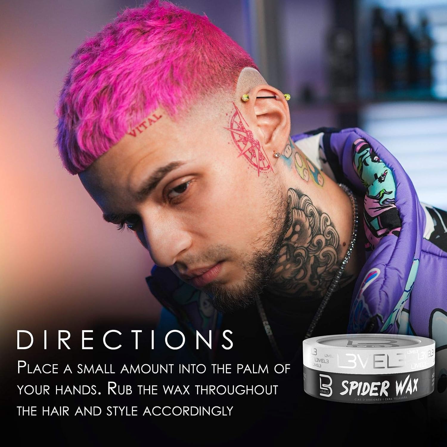 Person with pink hair and tattoos, wearing a colorful jacket, with Spider Wax product displayed.
