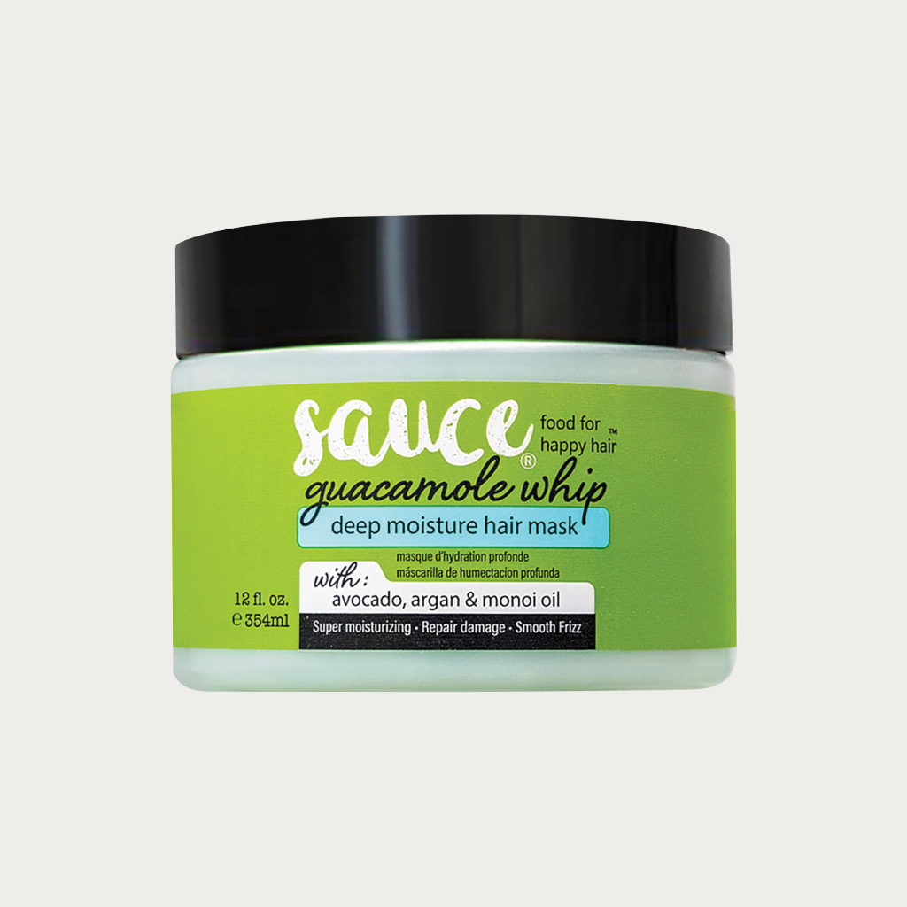 A jar of Sauce by The Hair Company 'Guacamole Whip' deep moisture hair mask, featuring a bright green label and a black lid, set against a light gray background.