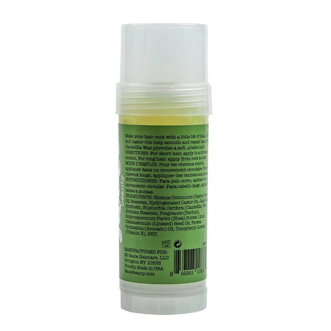 A bottle of hair oil shown from the back, featuring a translucent white cap and a light green label with black text, set against a plain white background.