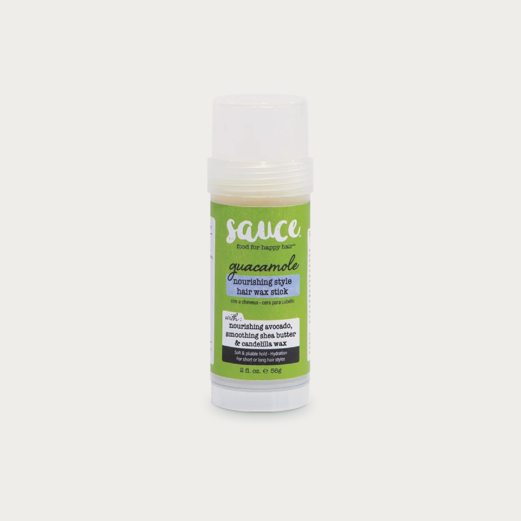 A single tube of Sauce Beauty brand Guacamole Enriching Hair Wax Stick on a light gray background.