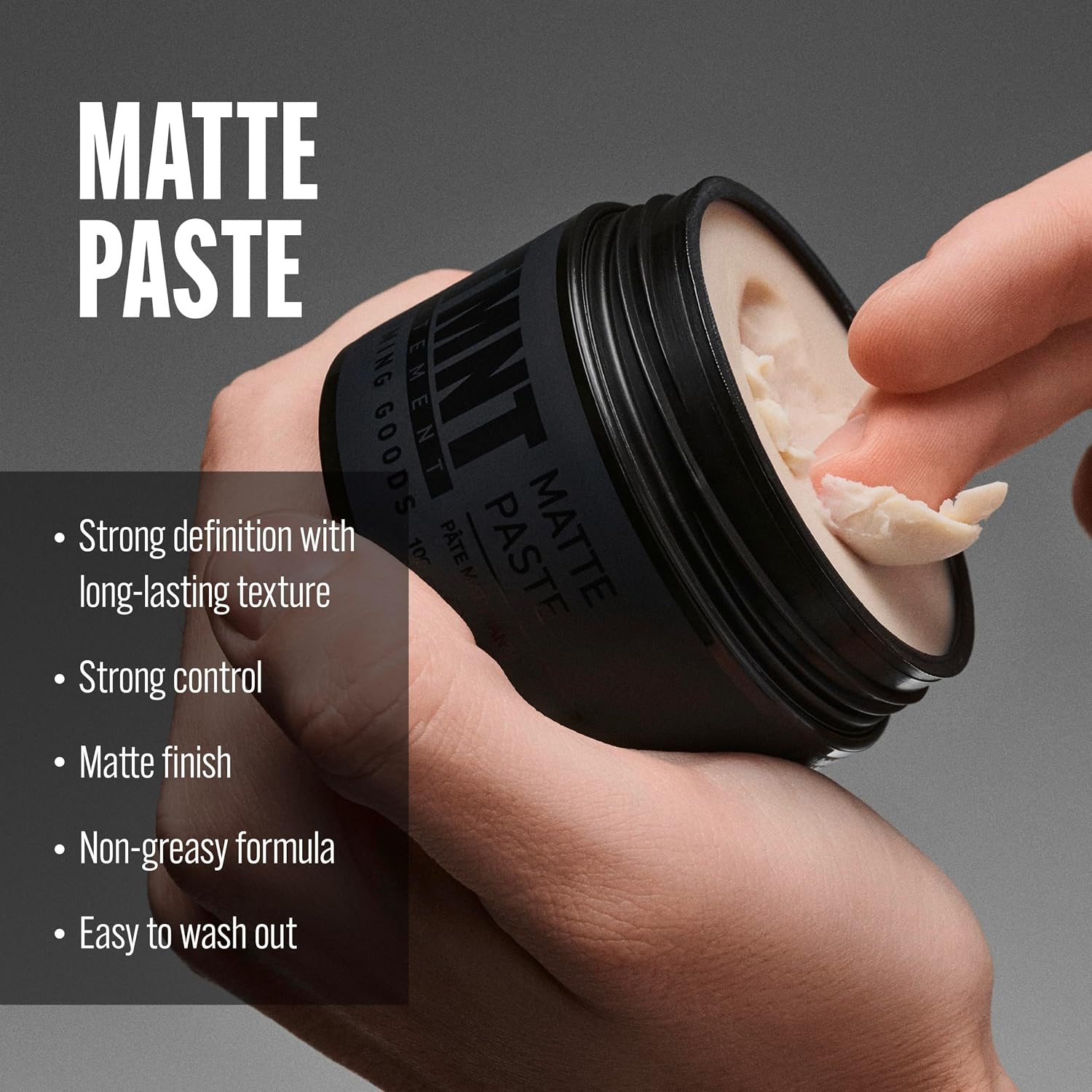 A hand holds an open black jar of matte paste makeup while another hand applies the cream product. Large white text reads 'MATTE PASTE' on a dark gray background, with bullet points describing the product benefits on the left.