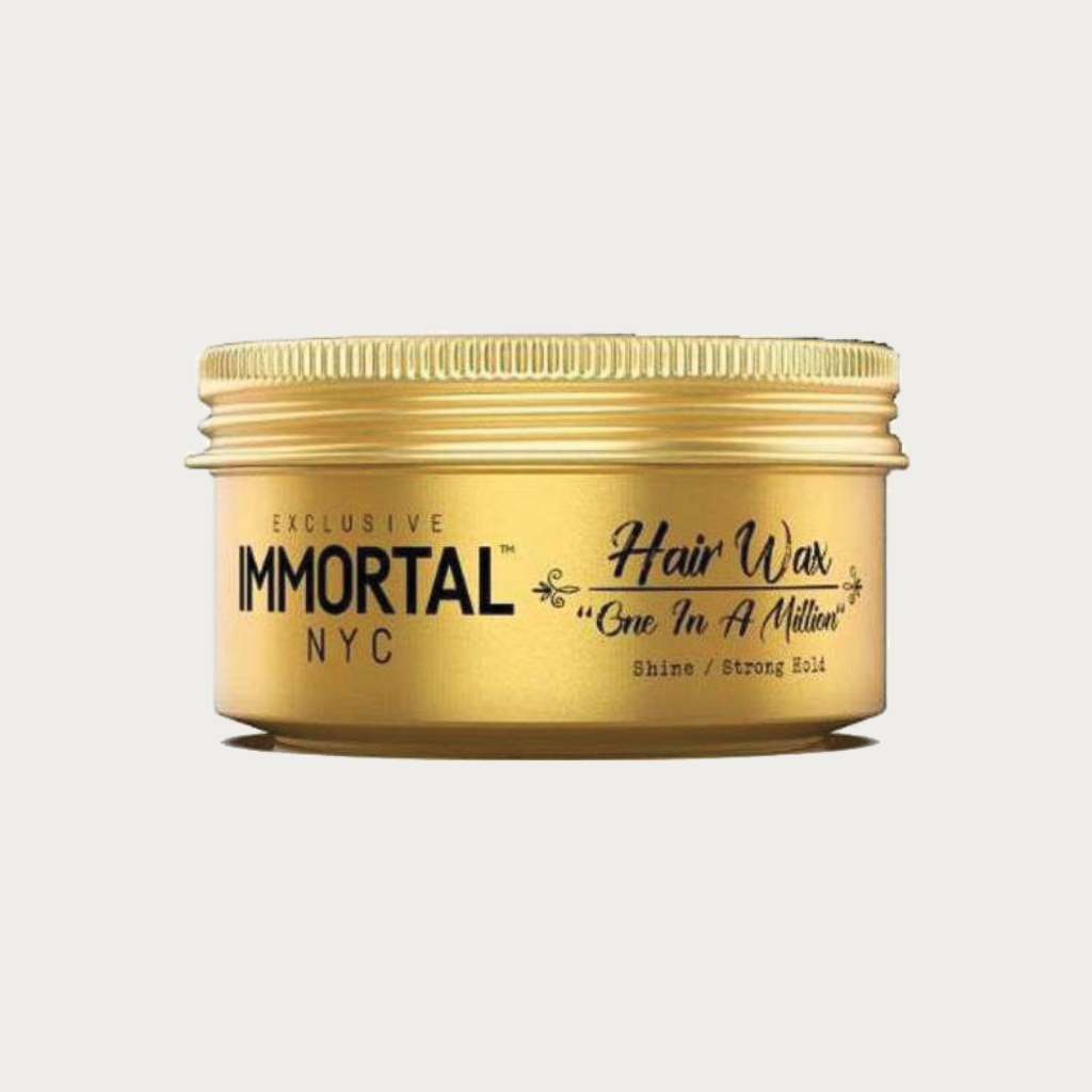 A gold metal jar of Immortal NYC Hair Wax on a light gray background.