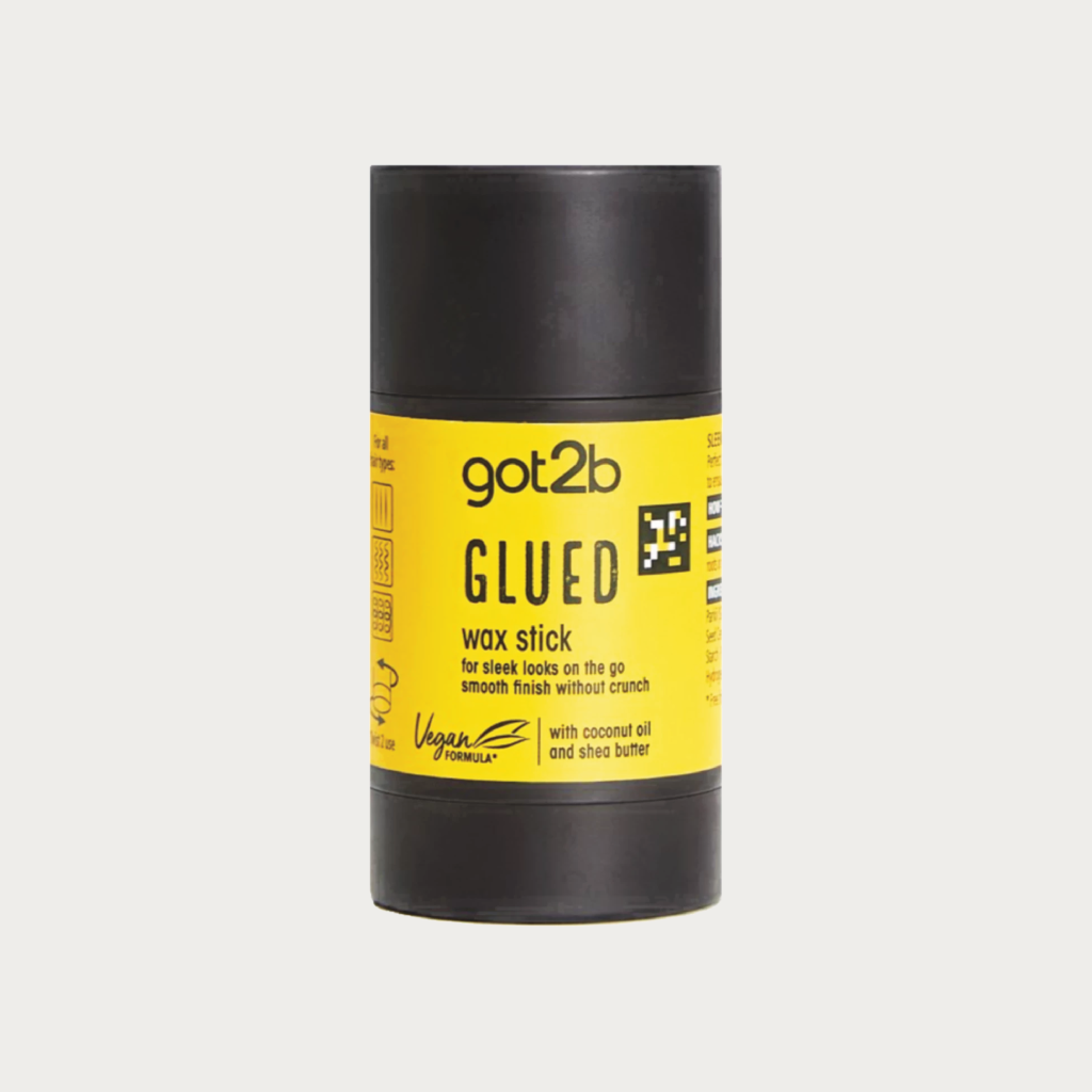 A black wax stick container with a bright yellow label reading 'got2b GLUED wax stick' on a light gray background.