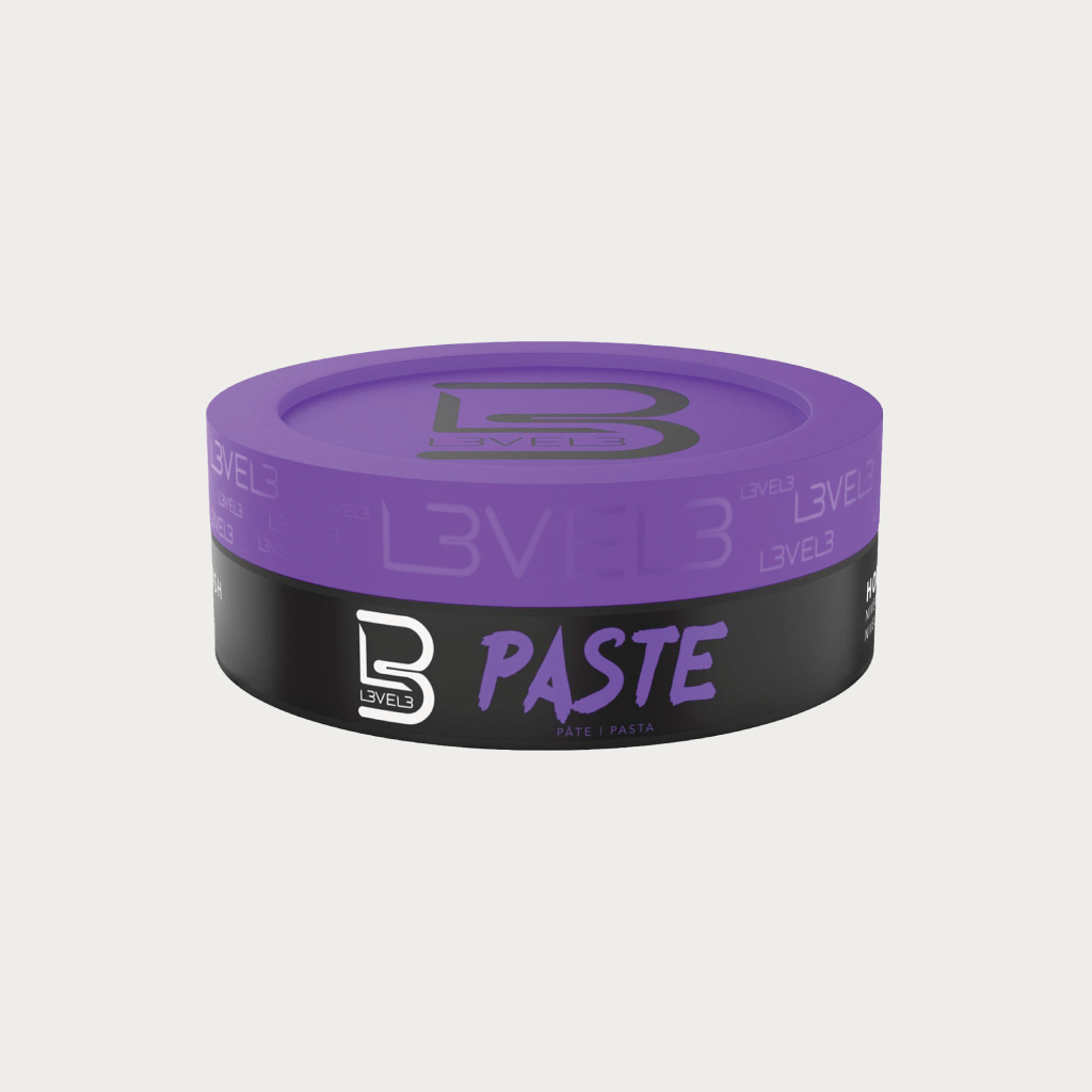 A round cosmetic jar of B Levels Paste hair color, featuring a purple lid and a black label with purple and white text, set against a light gray background.